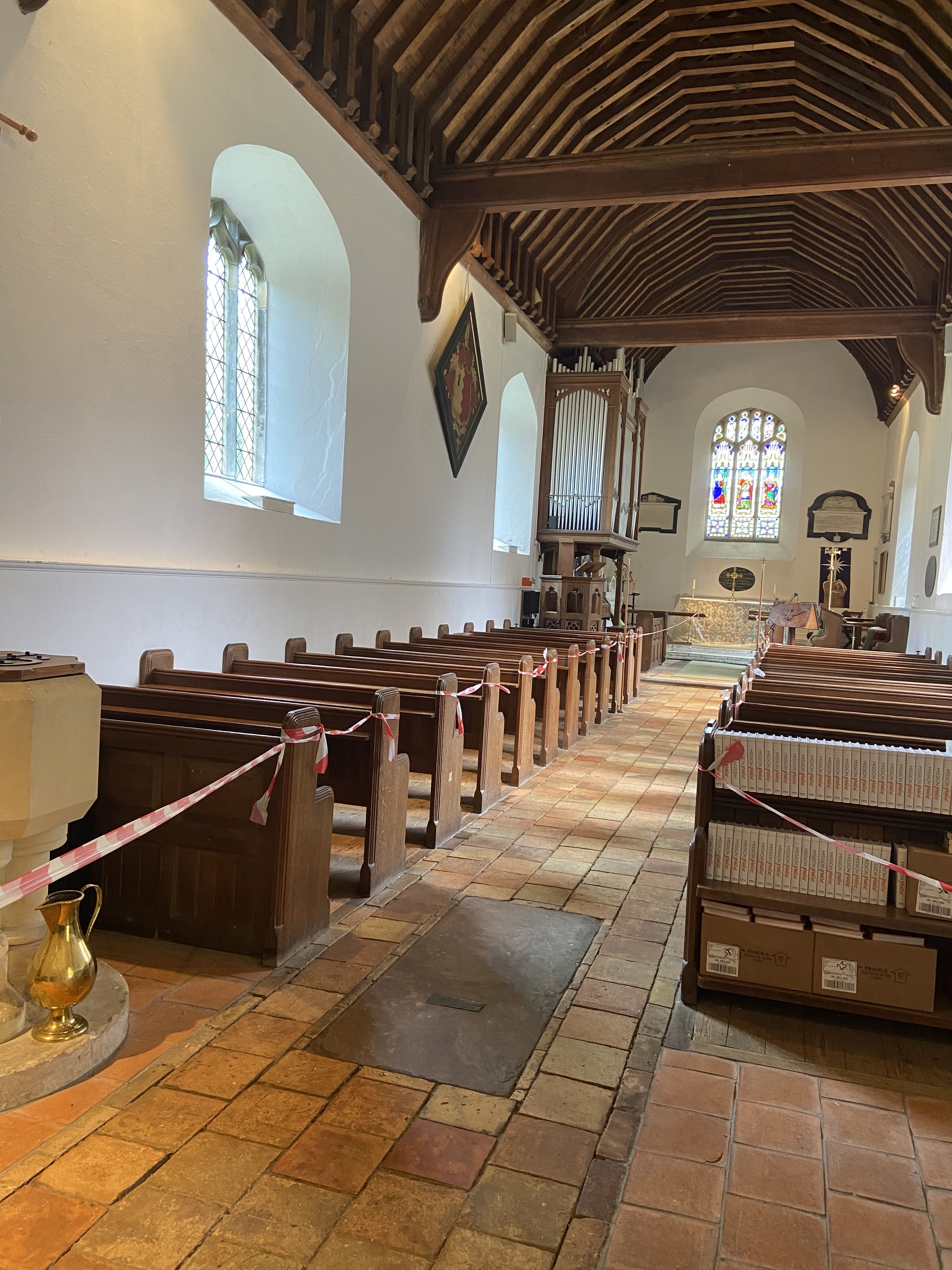 The interior of a church. The pews are cordoned off with warning tape.